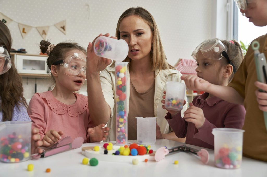 Children and teacher having science sensory exercises